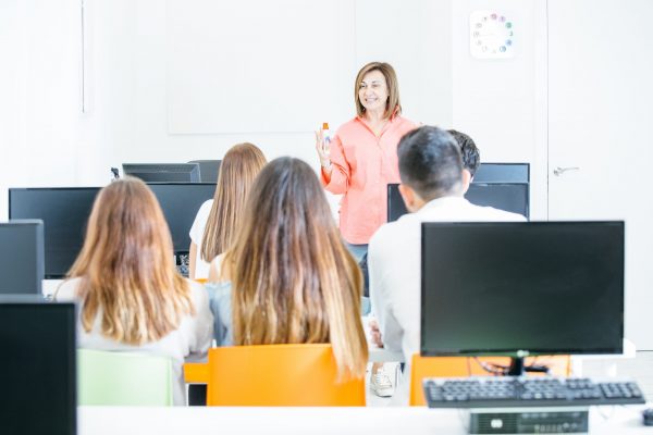 Cheerful tutor teaching students