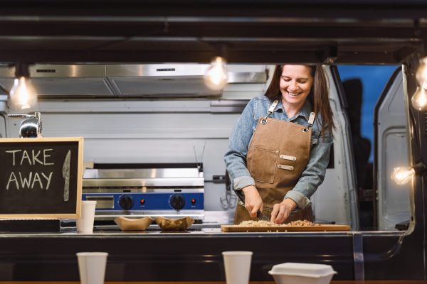 Food truck owner preparing meal recipe - Modern kitchen business and take away concept